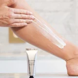 applying the dual action exfoliator on your leg