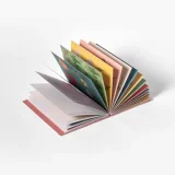 Open book of 24 individually designed postcards featuring an assortment of wil